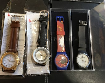 Four QANTAS collectable retro watches, all unused with new batteries.Black/Brown leather band,Aboriginal Kangaroo, black plane Sydney 2000