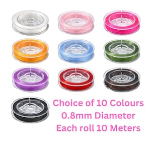 May include: Ten spools of 0.8mm diameter elastic cord, each 10 metres long. The spools are arranged in three rows, with colours including white, pink, fuchsia, orange, light blue, green, purple, red, brown, and black.