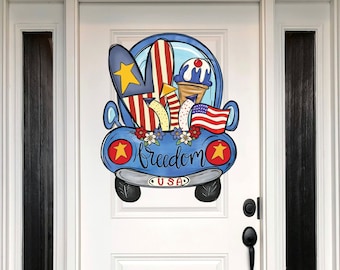 May include: A blue vintage car with a red, white, and blue American flag, surfboards, and an ice cream cone. The car has the word "Freedom" written on the side and "USA" on the back.