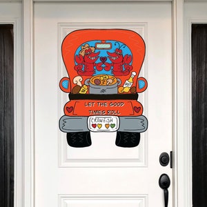 May include: A red truck with a crawfish design. The truck is decorated with crawfish, a pot of crawfish, and a bottle of hot sauce. The text on the truck says "Let the good times roll".