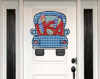 May include: A blue and white gingham truck with red, white, and blue fireworks spelling "USA" in the bed of the truck.