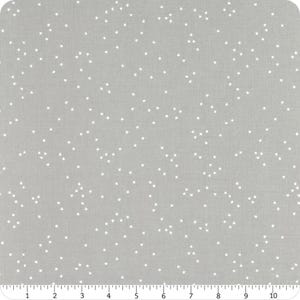 May include: A grey fabric with a white polka dot pattern. The dots are small and evenly spaced.