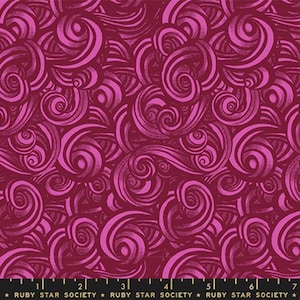 May include: A fabric featuring a repeating pattern of dark magenta and bright pink swirling, curved lines. A black measuring tape is visible at the bottom edge, showing measurements from 1 to 7 inches, with the text RUBY STAR SOCIETY.