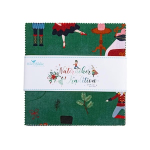 May include: A stack of square fabric pieces featuring a dark green background with Nutcracker-themed illustrations including dancers, pine branches, and bows. A white paper band wraps around the center with the text Nutcracker Tradition.