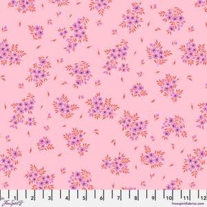 May include: Pink fabric with a repeating floral pattern. Clusters of purple flowers with orange-red leaves are scattered across the surface. The fabric has a ruler along the bottom edge with the text "freespiritfabrics.com".
