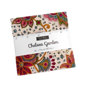 May include: A stack of fabric squares with a floral pattern in pink, teal, and gold. The fabric is labeled "Chelsea Garden by moda." A ruler is included in the packaging. The fabric squares are approximately 8 inches in length.