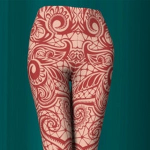 May include: Red leggings with a white intricate pattern. The pattern resembles a lace design.