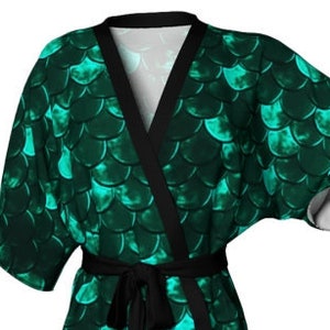 May include: A green and black robe with a mermaid scale pattern. The robe has a black sash and long sleeves.