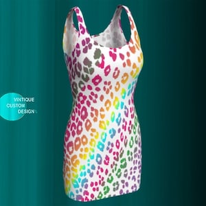 May include: A sleeveless white dress with a rainbow leopard print pattern. The dress has a scoop neck and a fitted silhouette.