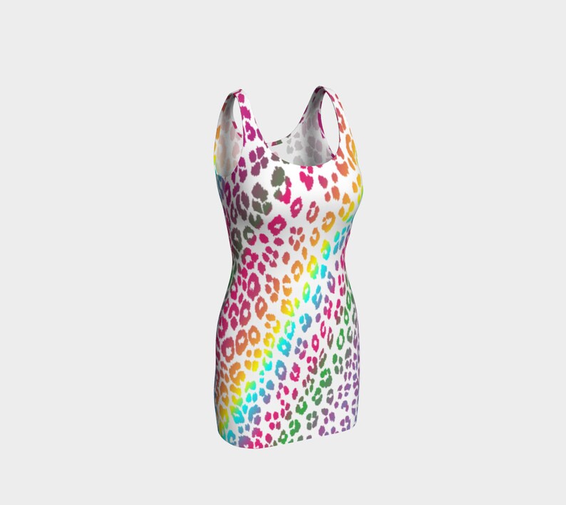 May include: A sleeveless mini dress with a white background and a rainbow leopard print pattern.