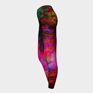 May include: A pair of black leggings with a colorful abstract print featuring shades of pink, red, orange, yellow, green, and blue.