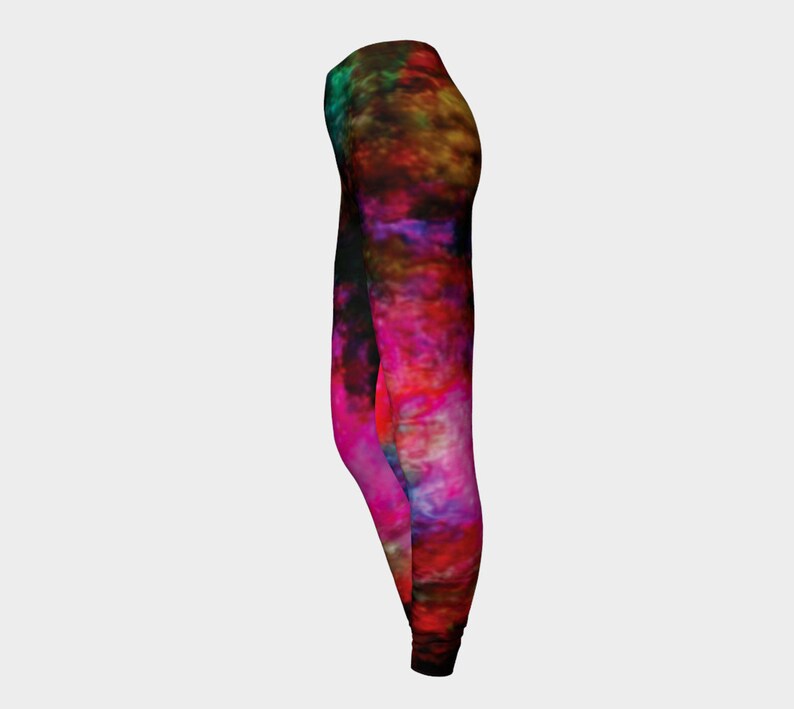 May include: A pair of black leggings with a colorful abstract print featuring shades of pink, red, orange, yellow, green, and blue.