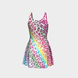 May include: A sleeveless white dress with a rainbow leopard print pattern. The dress has a fitted bodice and a flared skirt.