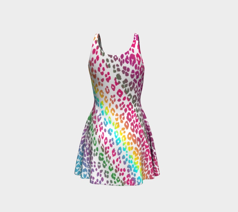 May include: A sleeveless white dress with a rainbow leopard print pattern. The dress has a fitted bodice and a flared skirt.
