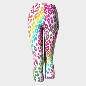 May include: Rainbow leopard print cropped leggings. The leggings are white with a rainbow leopard print pattern.