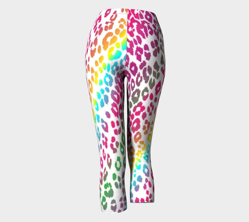 May include: Rainbow leopard print cropped leggings. The leggings are white with a rainbow leopard print pattern.