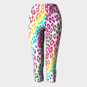 May include: Rainbow leopard print leggings with a white background. The leggings are cropped and have a fitted silhouette.