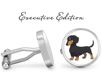 May include: Silver cufflinks with a black and brown dachshund illustration on one cufflink. The cufflinks are labeled "Executive Edition".