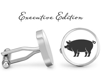 May include: A pair of silver cufflinks with a black pig silhouette on one cufflink. The cufflinks are labeled "Executive Edition".