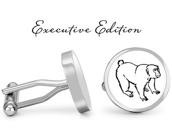 May include: Silver cufflinks with a black and white illustration of a monkey on one cufflink. The cufflinks are labeled "Executive Edition".