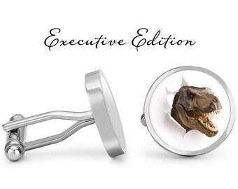 May include: Silver cufflinks with a round design. One cufflink features a white background with a T-Rex dinosaur head breaking through the surface. The other cufflink is plain silver. The text "Executive Edition" is written above the cufflinks.