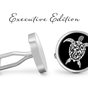 May include: A pair of silver cufflinks with a black background and a white stylized turtle design. The cufflinks are labeled "Executive Edition".