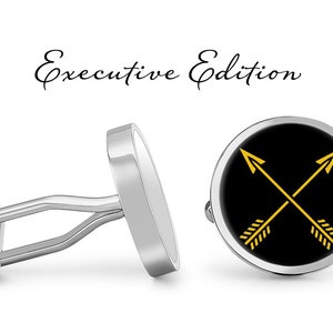 May include: A pair of silver cufflinks with a black background and gold crossed arrows. The cufflinks are labeled "Executive Edition".