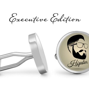 May include: Silver cufflinks with a round, cream-colored design featuring a black silhouette of a man with a beard and glasses. The text "Hipster" is written in cursive below the image.