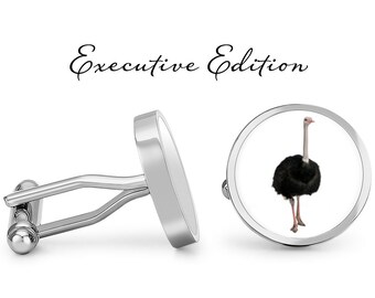 May include: Silver cufflinks with a round design featuring an ostrich. The cufflinks are labeled "Executive Edition".