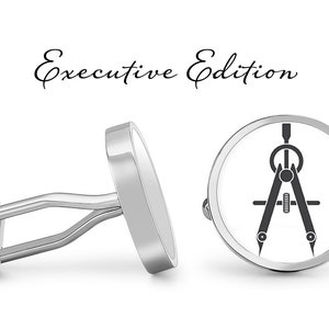 May include: Silver cufflinks with a compass design. The cufflinks are round and have a white background with a black compass design. The text "Executive Edition" is written above the cufflinks.