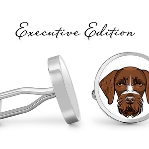 May include: Silver cufflinks with a white background and a brown and white dog illustration. The cufflinks say "Executive Edition" above the dog.