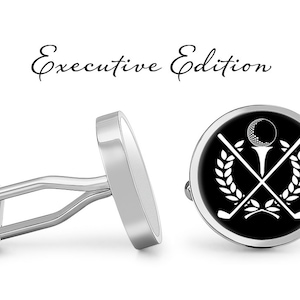 May include: A pair of silver cufflinks with a black background and a white golf club and ball design. The cufflinks have the text "Executive Edition" above them.