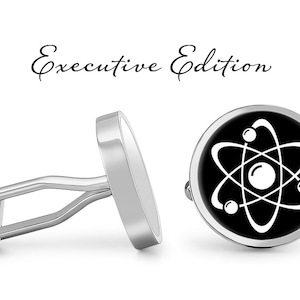 May include: A pair of silver cufflinks with a black background and a white atom symbol. The cufflinks are labeled "Executive Edition".