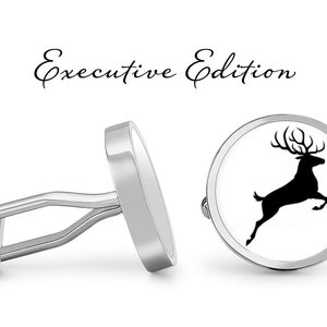 May include: A pair of silver cufflinks with a white background and a black silhouette of a leaping deer. The cufflinks are labeled "Executive Edition".