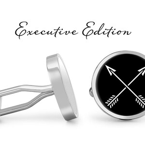 May include: Silver cufflinks with a black background and two white crossed arrows. The cufflinks are labeled "Executive Edition".