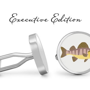 May include: Silver cufflinks with a white background and a detailed illustration of a perch fish. The cufflinks are labeled "Executive Edition".