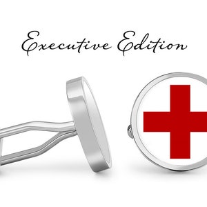 May include: A pair of silver cufflinks with a red cross design. The cufflinks are labeled "Executive Edition".