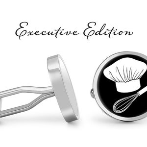 May include: Silver cufflinks with a black and white design of a chef's hat and whisk. The cufflinks are labeled "Executive Edition".