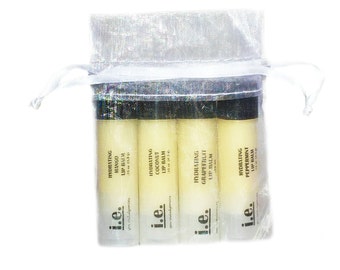 May include: Set of four hydrating lip balms in a white organza bag. The lip balms are labeled with the flavors: Mango, Coconut, Grapefruit, and Peppermint.