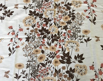 May include: Cream-colored fabric with a repeating floral pattern. The design features various flowers in shades of brown, peach, and tan, along with dark brown leaves and stems. The overall aesthetic is reminiscent of vintage textiles.