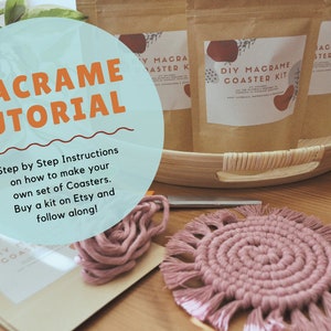 May include: A close-up of a macrame coaster kit with instructions on how to make your own set of coasters. The kit is pink and includes yarn, a wooden tray, and a finished coaster. The image also includes the text "MACRAME TUTORIAL" and "marit malewitz designs".