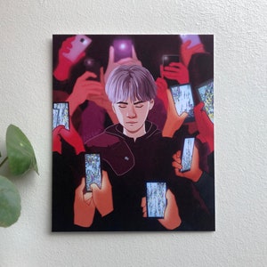 May include: A young person with purple hair is surrounded by people holding up phones, all of which are displaying images of crowds. The person in the center of the image is looking down with a somber expression.