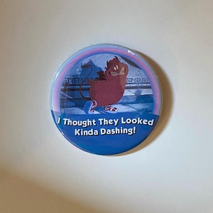 May include: A round button with a cartoon image of a red character with horns and a tail, wearing blue shoes. The button has the text "I Thought They Looked Kinda Dashing!" in white letters on a blue background.