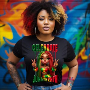 May include: Black t-shirt with the words "CELEBRATE JUNETEENTH" in green and red. The shirt features a cartoon illustration of a woman with red, green, and yellow hair and clothing, making a peace sign with both hands. The background is a colorful mural.
