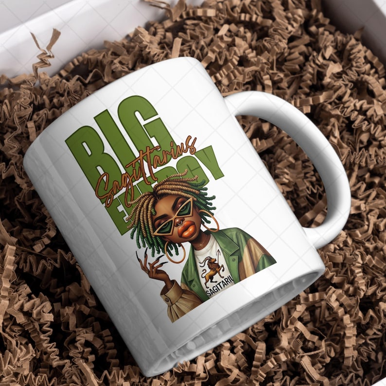 May include: White ceramic mug featuring a graphic of a woman with green-tinted sunglasses and the words "BIG Sagittarius ENERGY" in green. The woman is wearing a green jacket and gold hoop earrings. The mug is in a gift box with brown packing material.