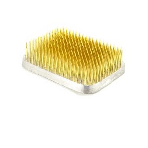May include: A rectangular floral foam with a silver base and gold-colored pins. The foam is designed for arranging flowers.