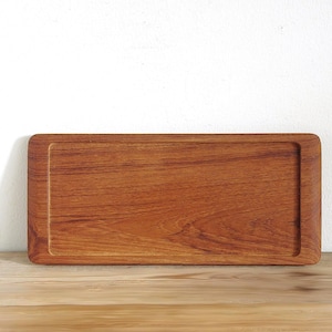 May include: A rectangular wooden tray with a smooth, polished finish and a warm, reddish-brown grain pattern. The tray features a recessed center area with rounded corners and a raised, flat border surrounding the entire perimeter of the object.