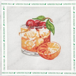 May include: Needlepoint canvas depicting a cocktail with cherries, ice, and an orange slice. The drink is in a clear glass. The canvas has a border with the text "WINSTON TALES" in green.