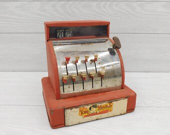 Gold With Black Print and Designs With Red Bottom Vintage Toy Cash Register Black and Red Plastic Handle Push Buttons to Raise Numbers.