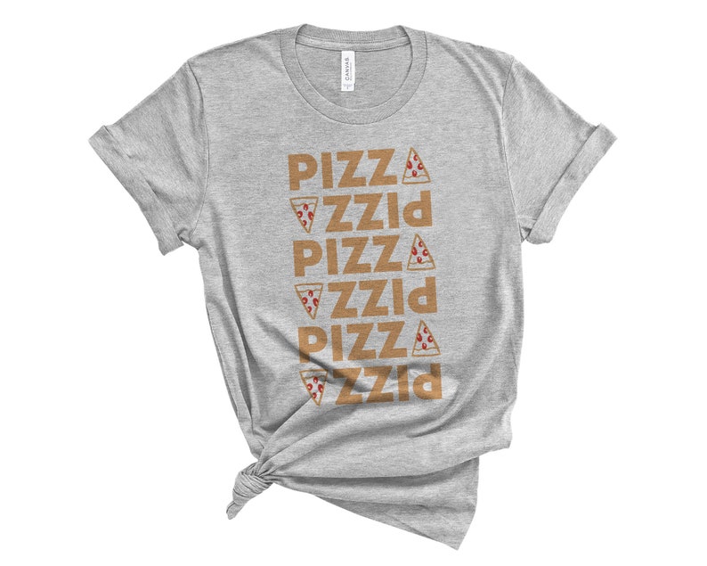 May include: A heather gray t-shirt with the word "PIZZA" repeated vertically five times in a brown font. Each instance of the word has a pizza slice graphic. The shirt is knotted at the bottom.